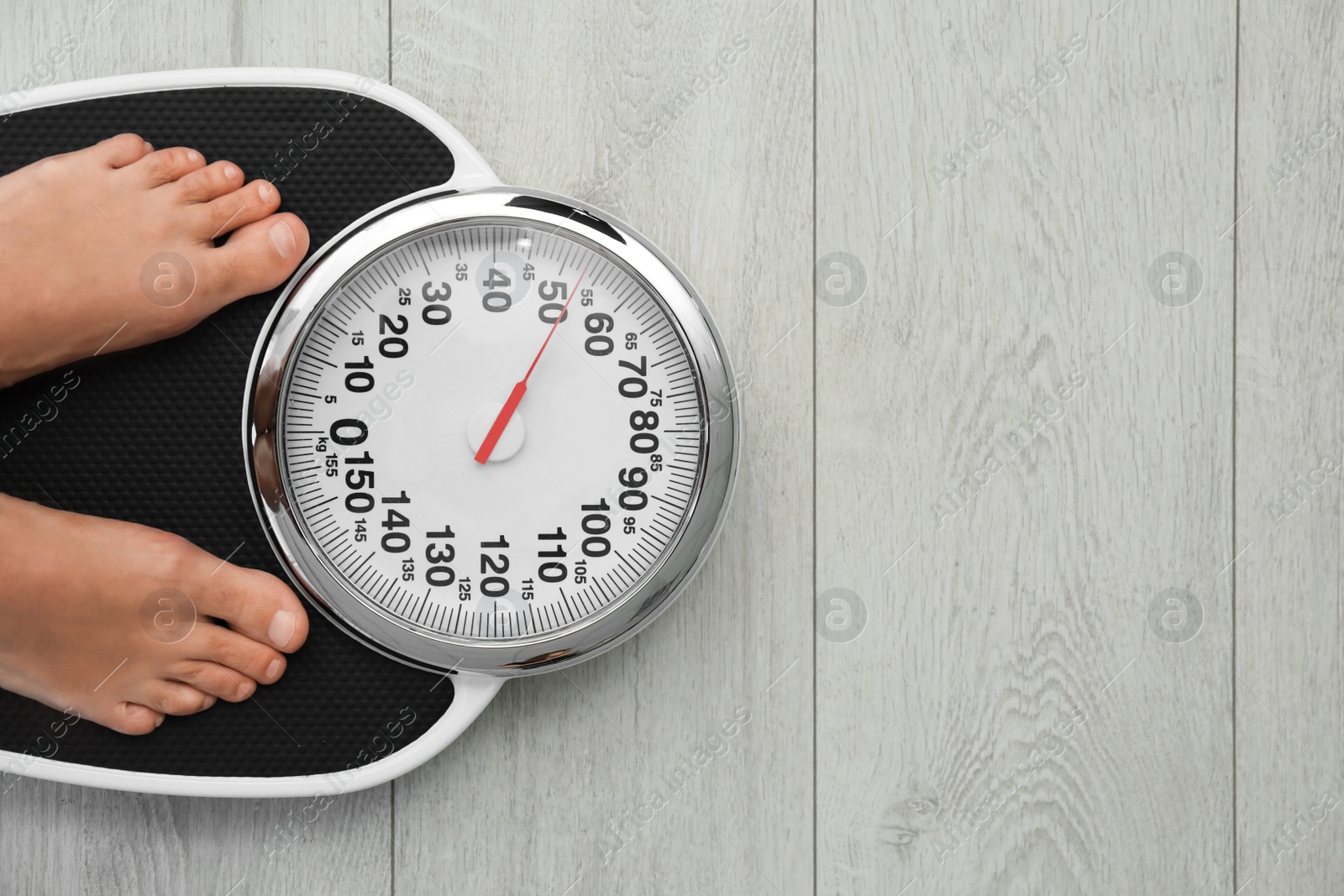 Photo of Woman standing on scales indoors, top view with space for text. Overweight problem