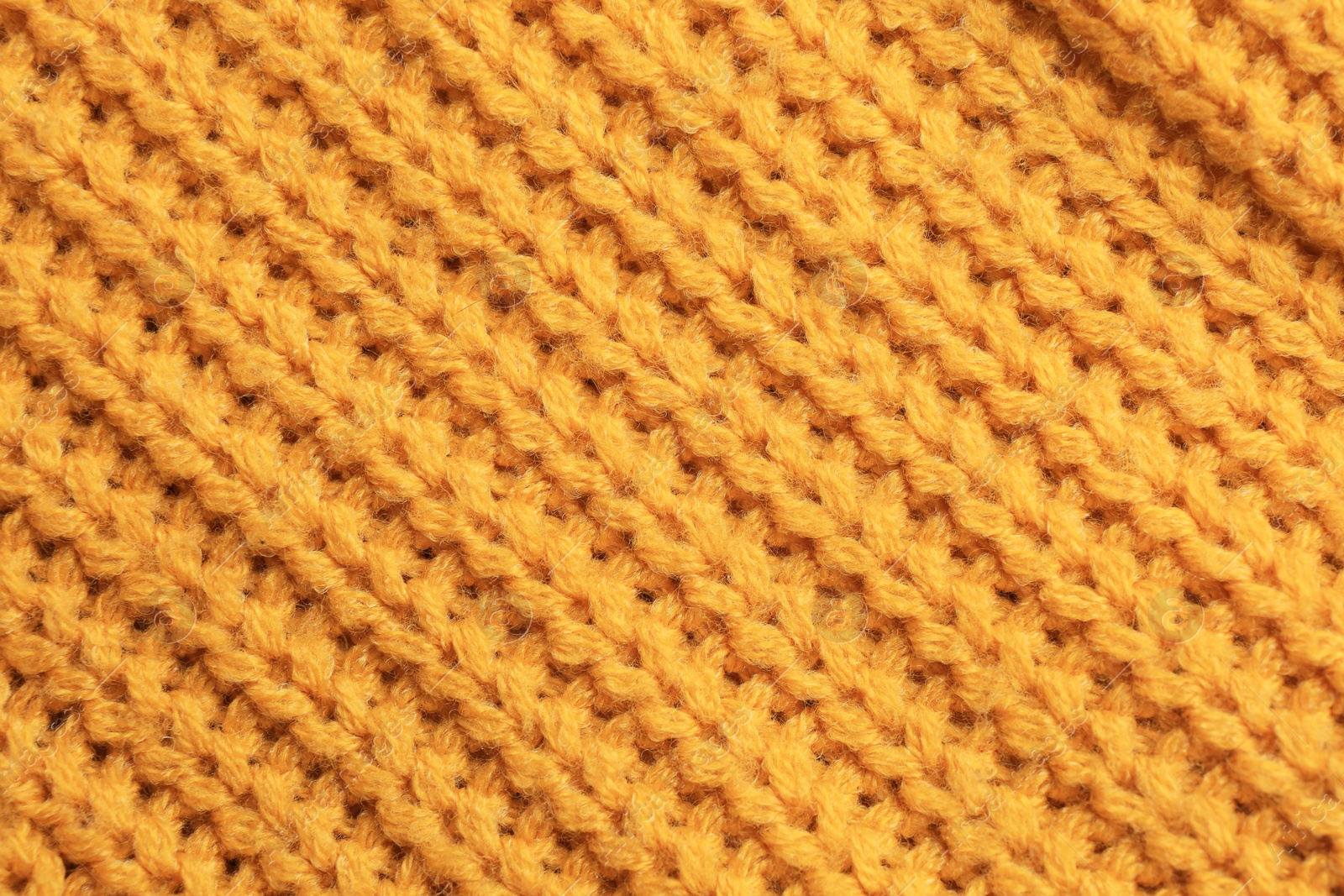 Photo of Beautiful orange knitted fabric as background, top view