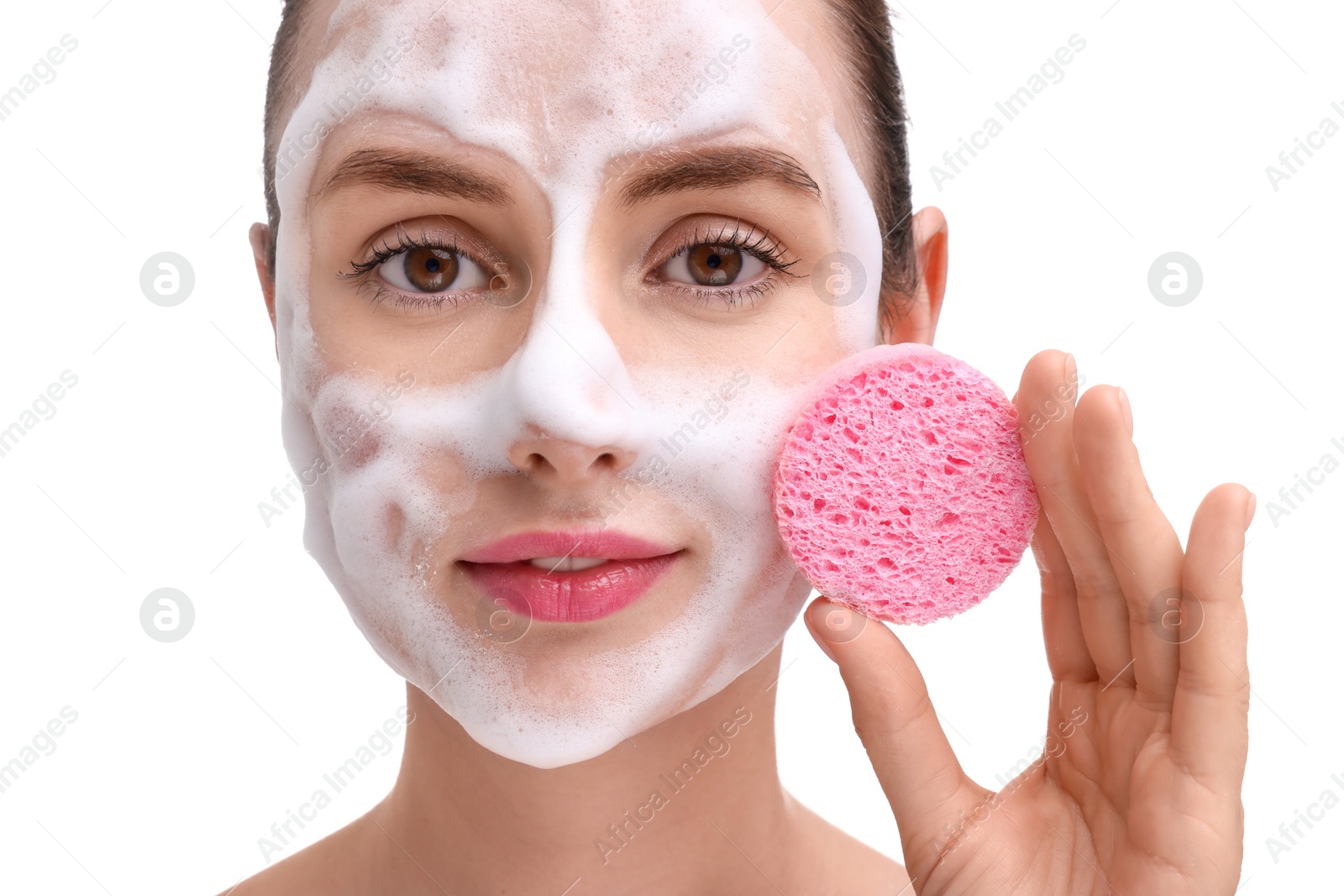 Photo of Young woman washing her face with sponge on white background