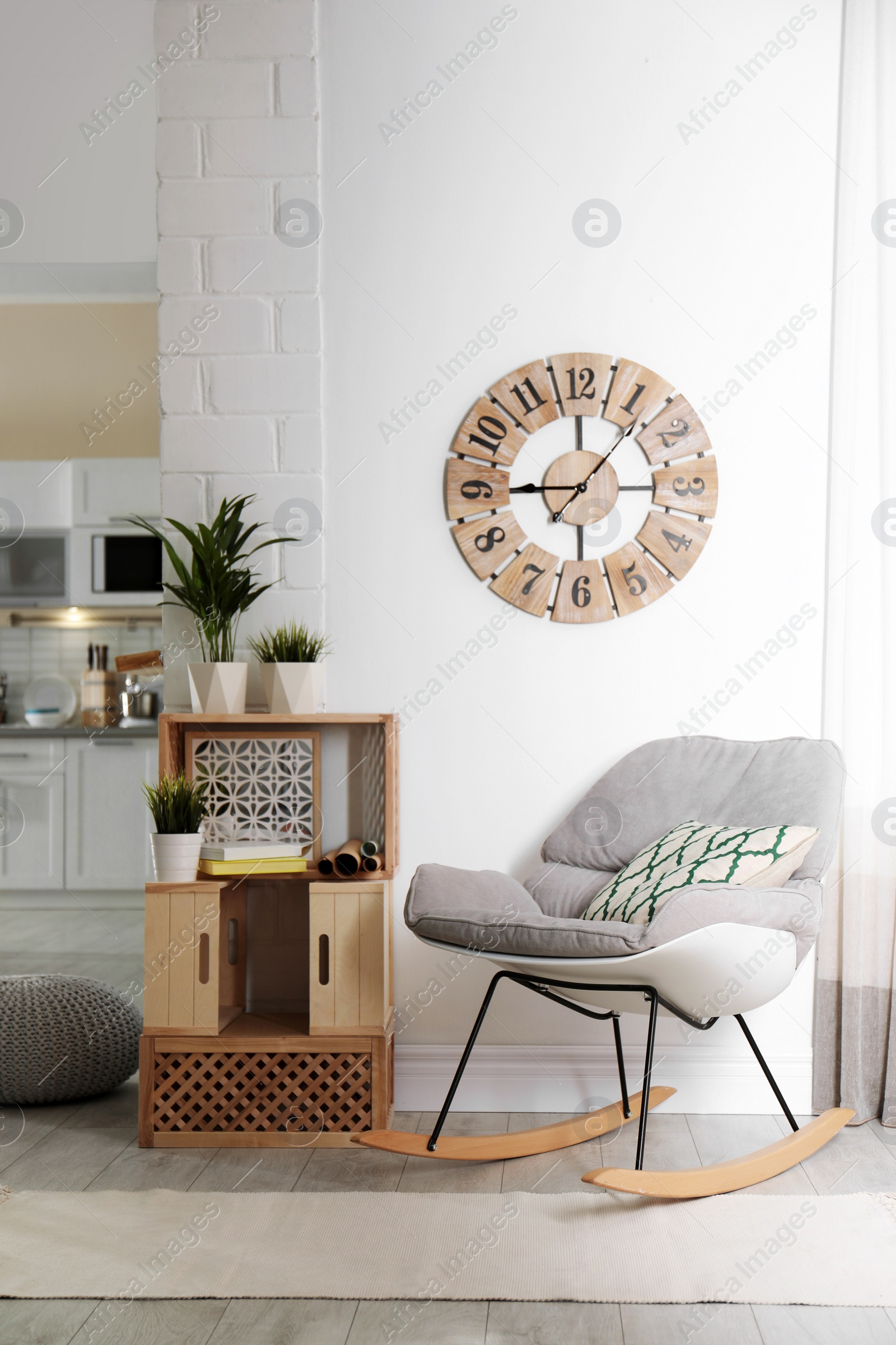 Photo of Rocking chair and wooden crates in room interior. Eco style