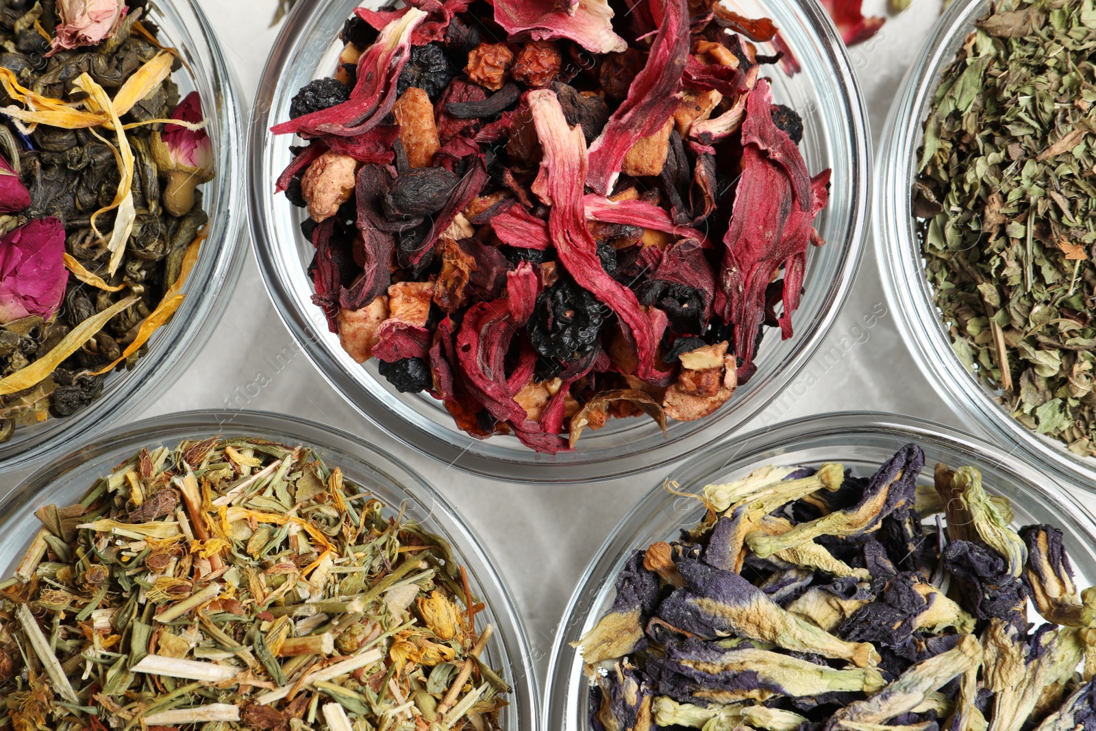 Photo of Flat lay composition with different dry teas on light table