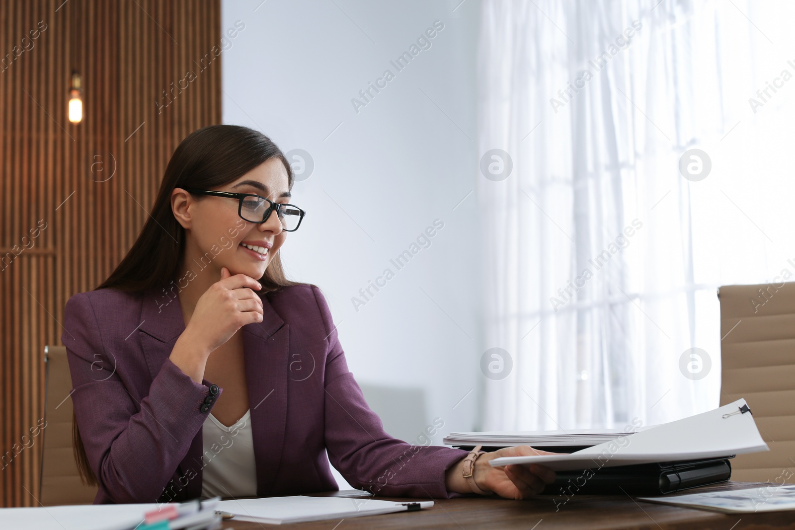 Photo of Beautiful businesswoman working with documents at table in office. Space for text