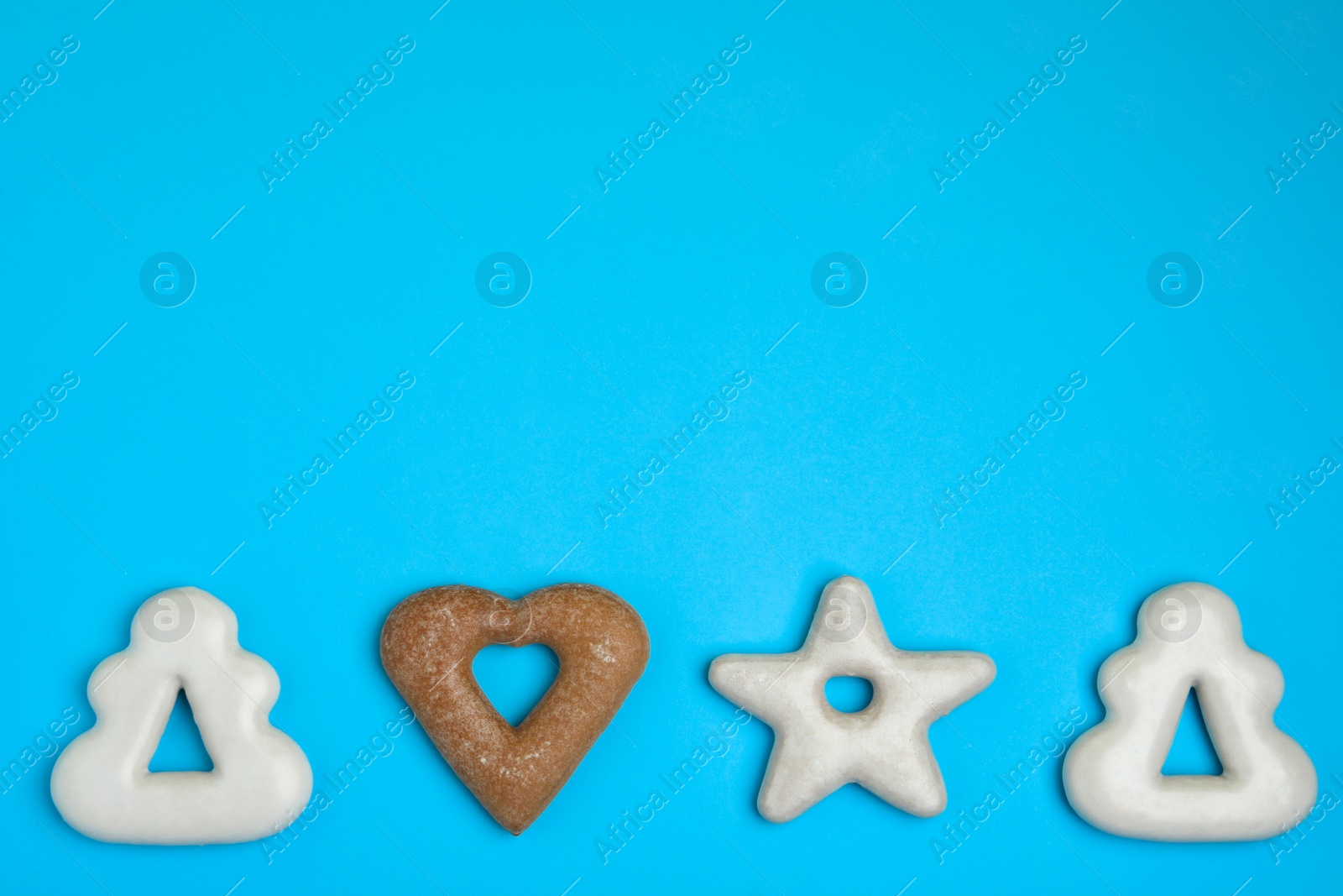 Photo of Tasty homemade cookies on light blue background, flat lay. Space for text