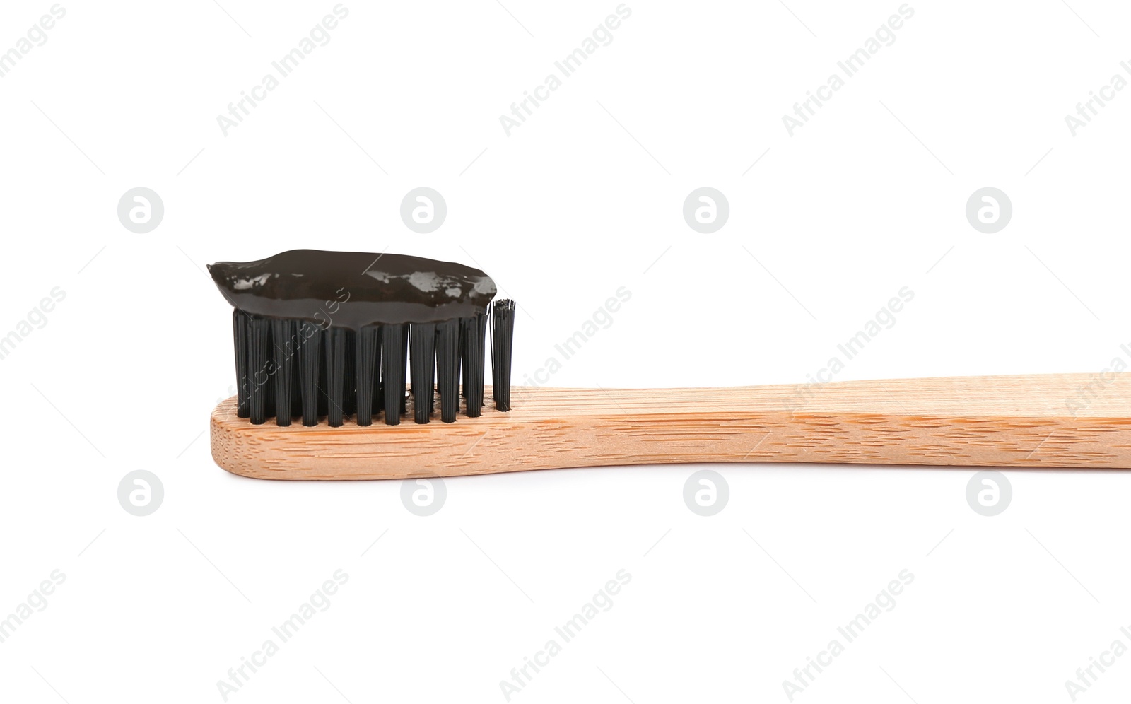 Photo of Bamboo toothbrush with charcoal paste isolated on white