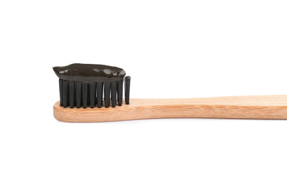 Photo of Bamboo toothbrush with charcoal paste isolated on white