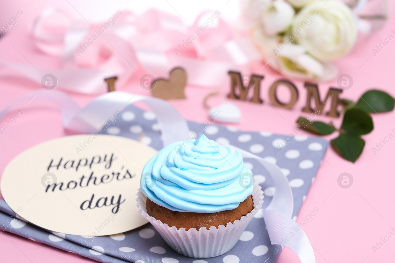 Photo of Festive surprise with tasty treat for Mother's Day on color background