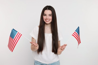Photo of 4th of July - Independence Day of USA. Happy girl with American flags on white background