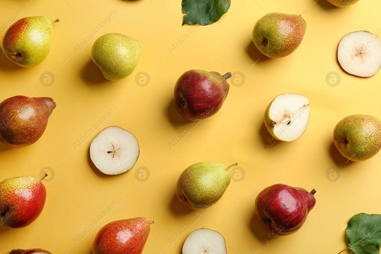 Photo of Ripe juicy pears on yellow background, flat lay