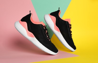 Photo of Pair of stylish sport shoes on color background