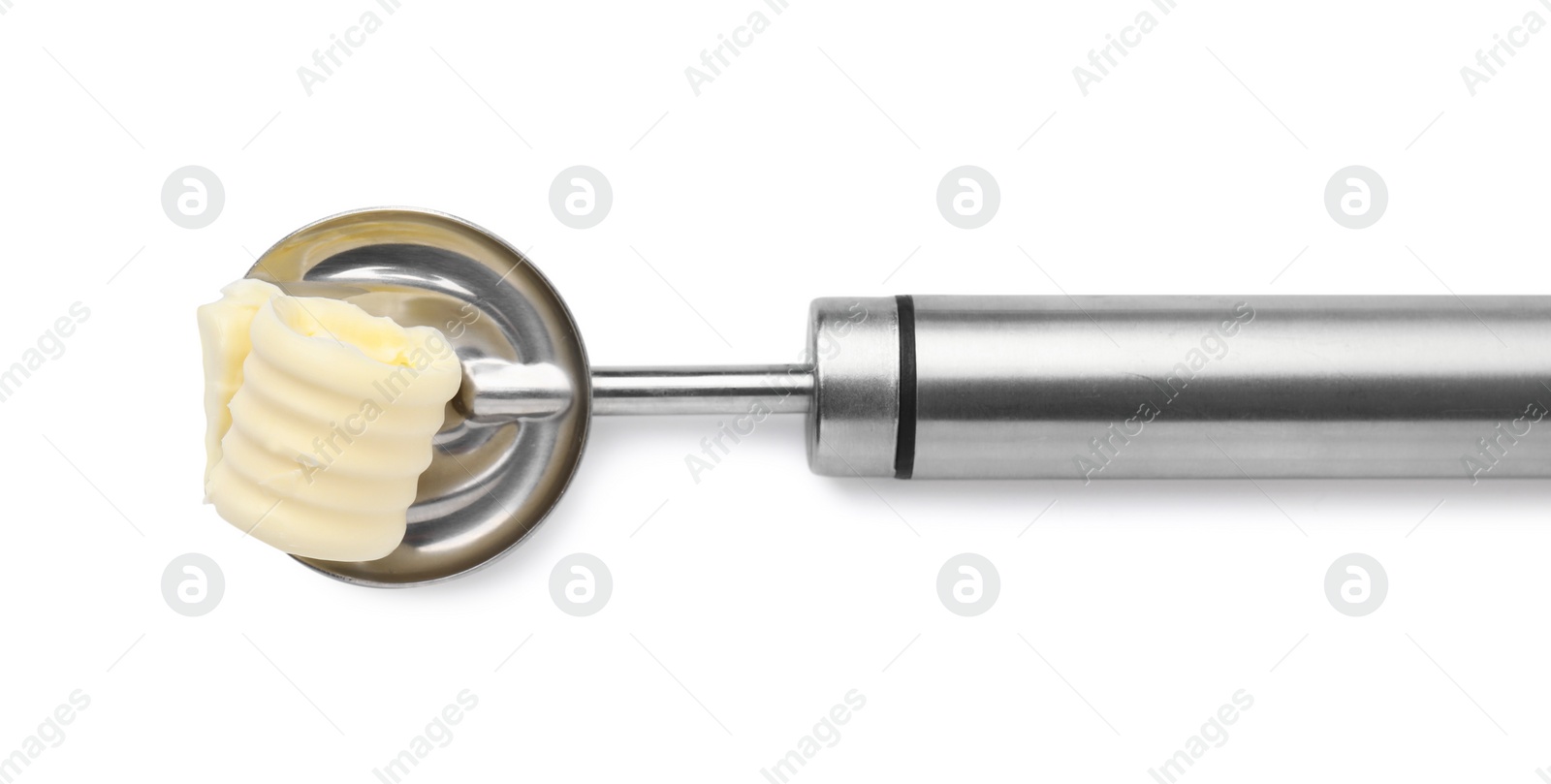 Photo of Butter curl in spoon isolated on white, top view