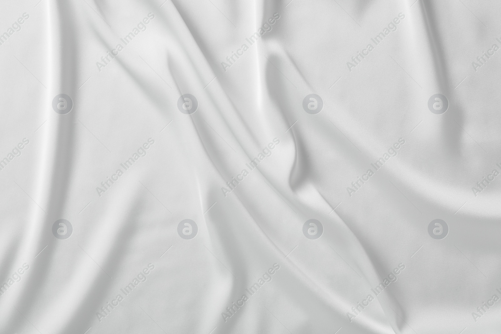 Photo of Texture of white silk ripple fabric as background, top view