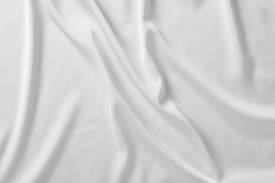 Photo of Texture of white silk ripple fabric as background, top view