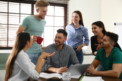 Group of happy people with laptop in office