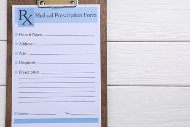 Photo of Medical prescription form with empty fields on white wooden table, top view. Space for text