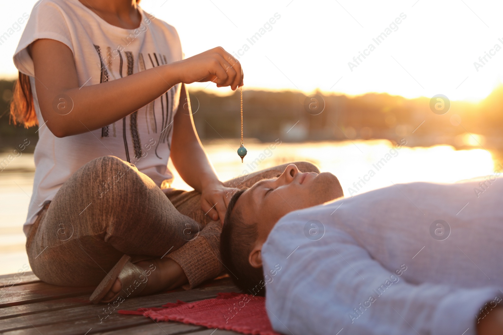 Photo of Man at crystal healing session near river outdoors