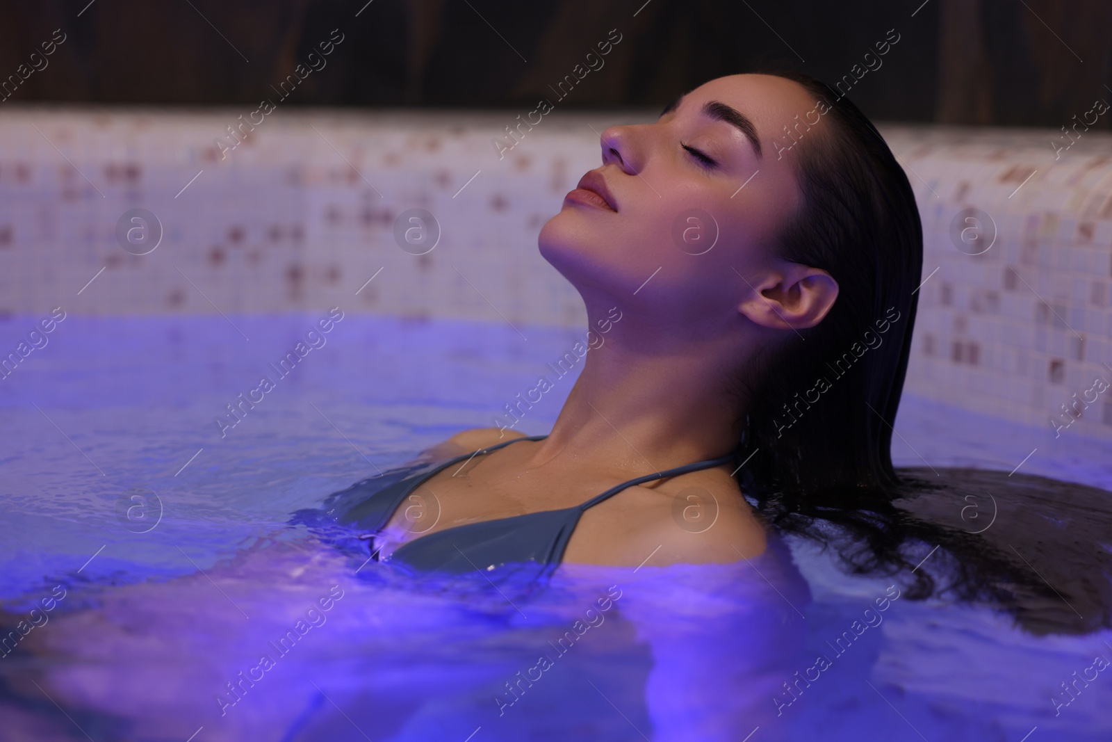 Photo of Beautiful woman relaxing in spa swimming pool