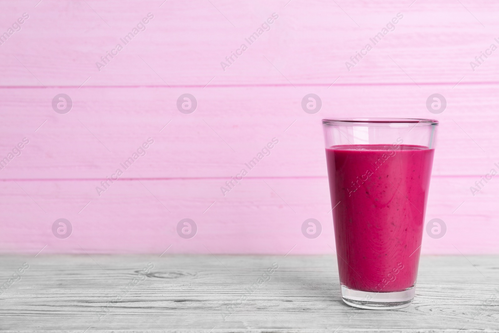 Photo of Glass with delicious detox smoothie on table