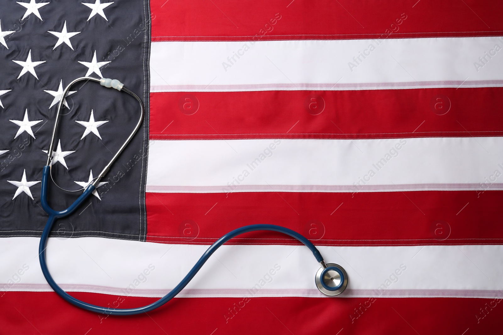 Photo of Stethoscope on American flag, top view. Space for text