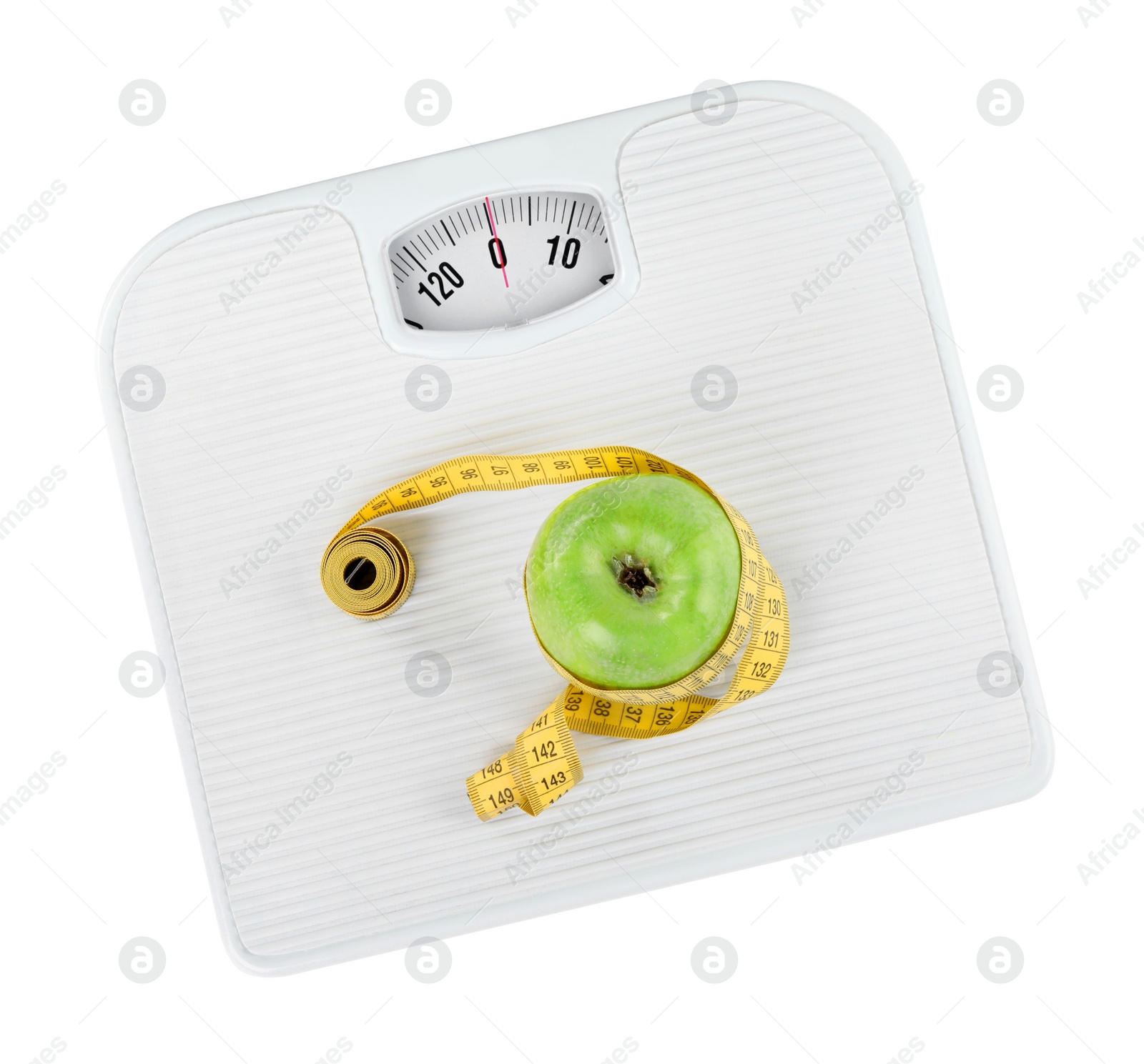 Photo of Weight loss concept. Ripe apple and measuring tape on scales isolated on white, top view