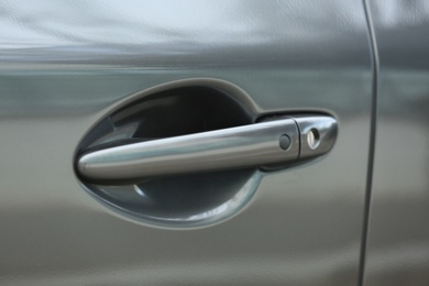 Closeup view of car door with handle