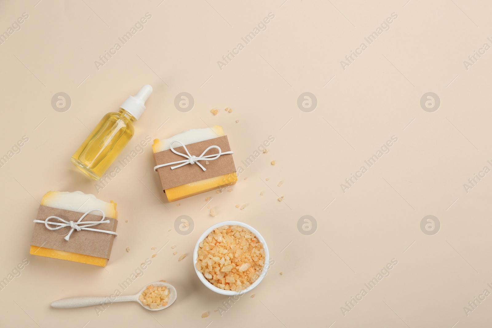 Photo of Flat lay composition with natural handmade soap on beige background. Space for text
