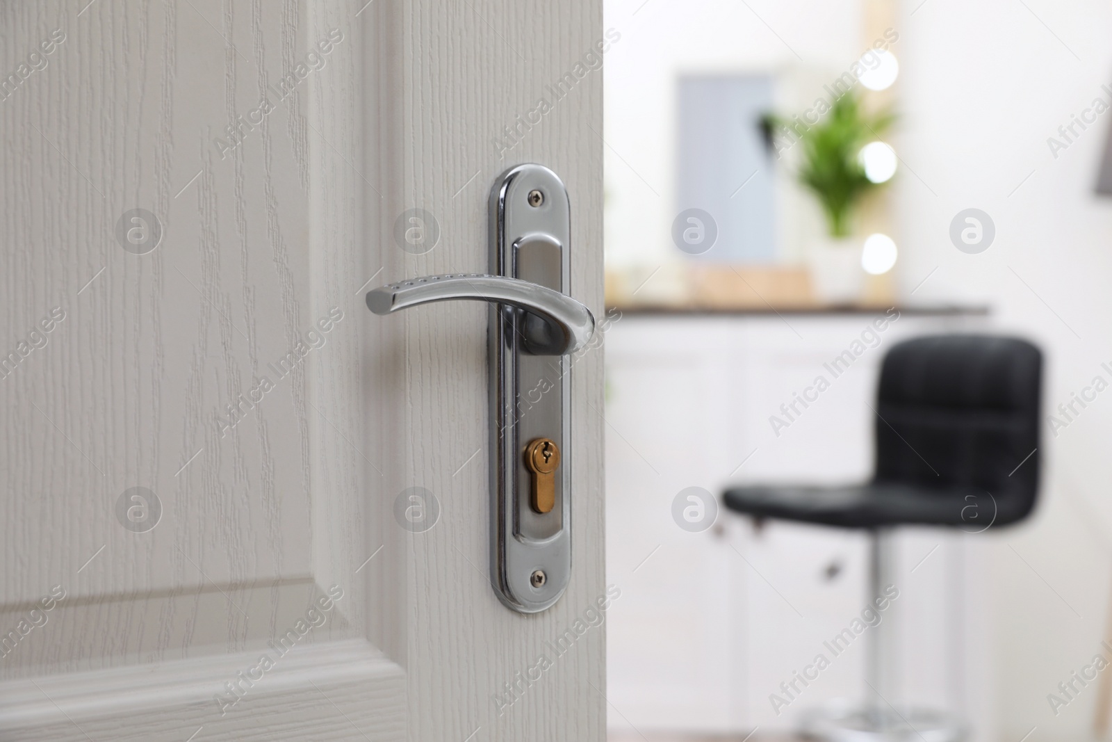 Photo of Closeup of open door in modern apartment, space for text