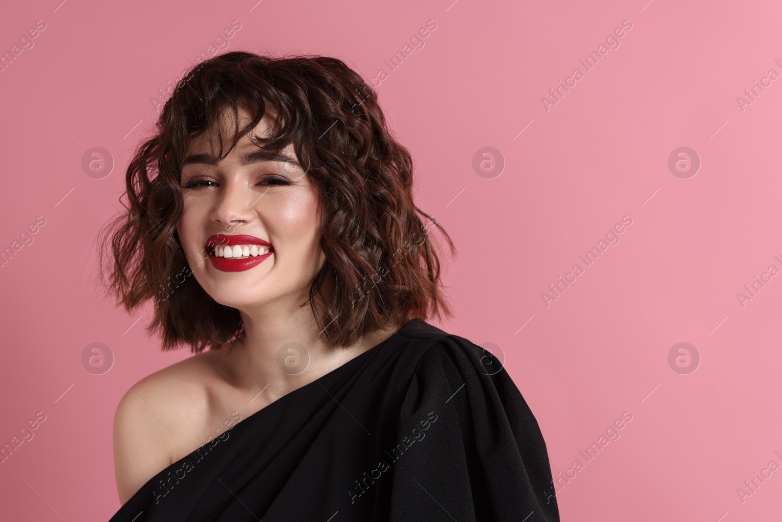 Photo of Portrait of beautiful young woman with wavy hairstyle on pink background. Space for text