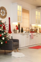 Photo of Cozy kitchen interior with Christmas tree and beautiful festive decor