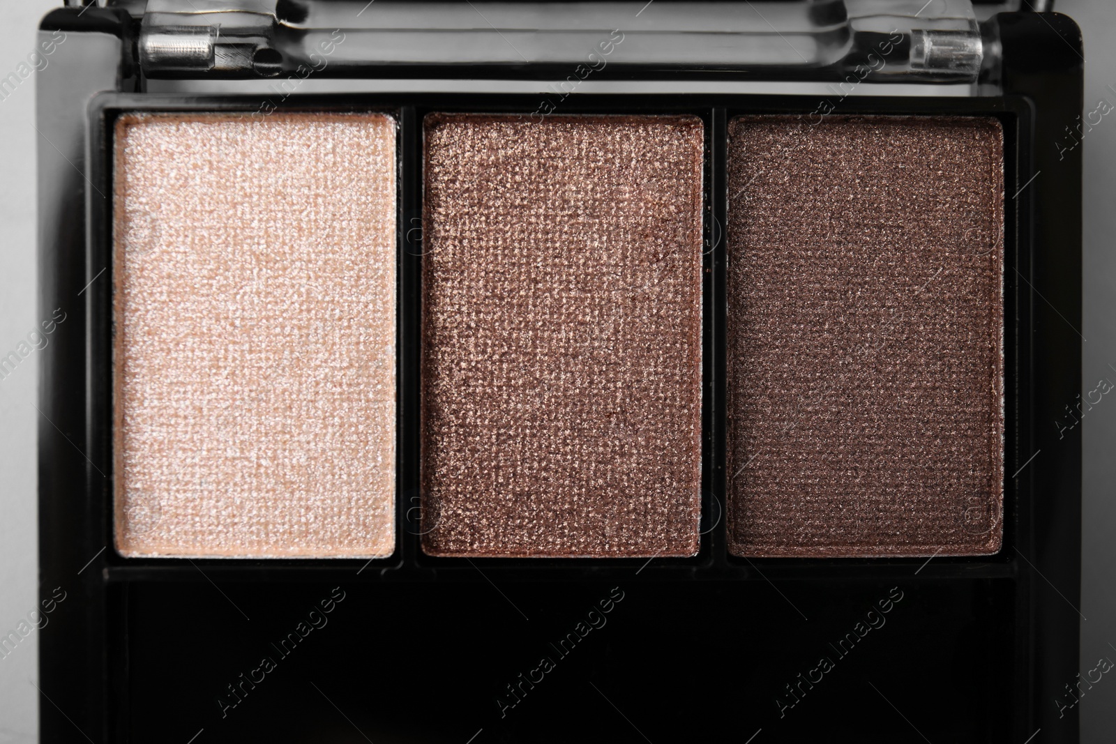 Photo of Beautiful eyeshadow palette on light gray background, closeup. Professional cosmetic product