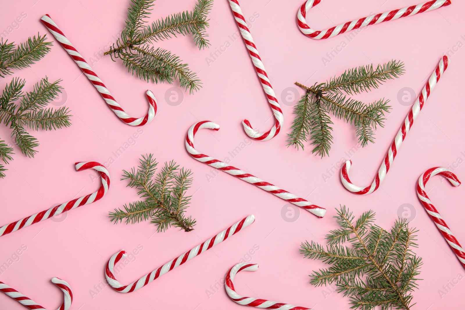 Photo of Flat lay composition with tasty candy canes on color background