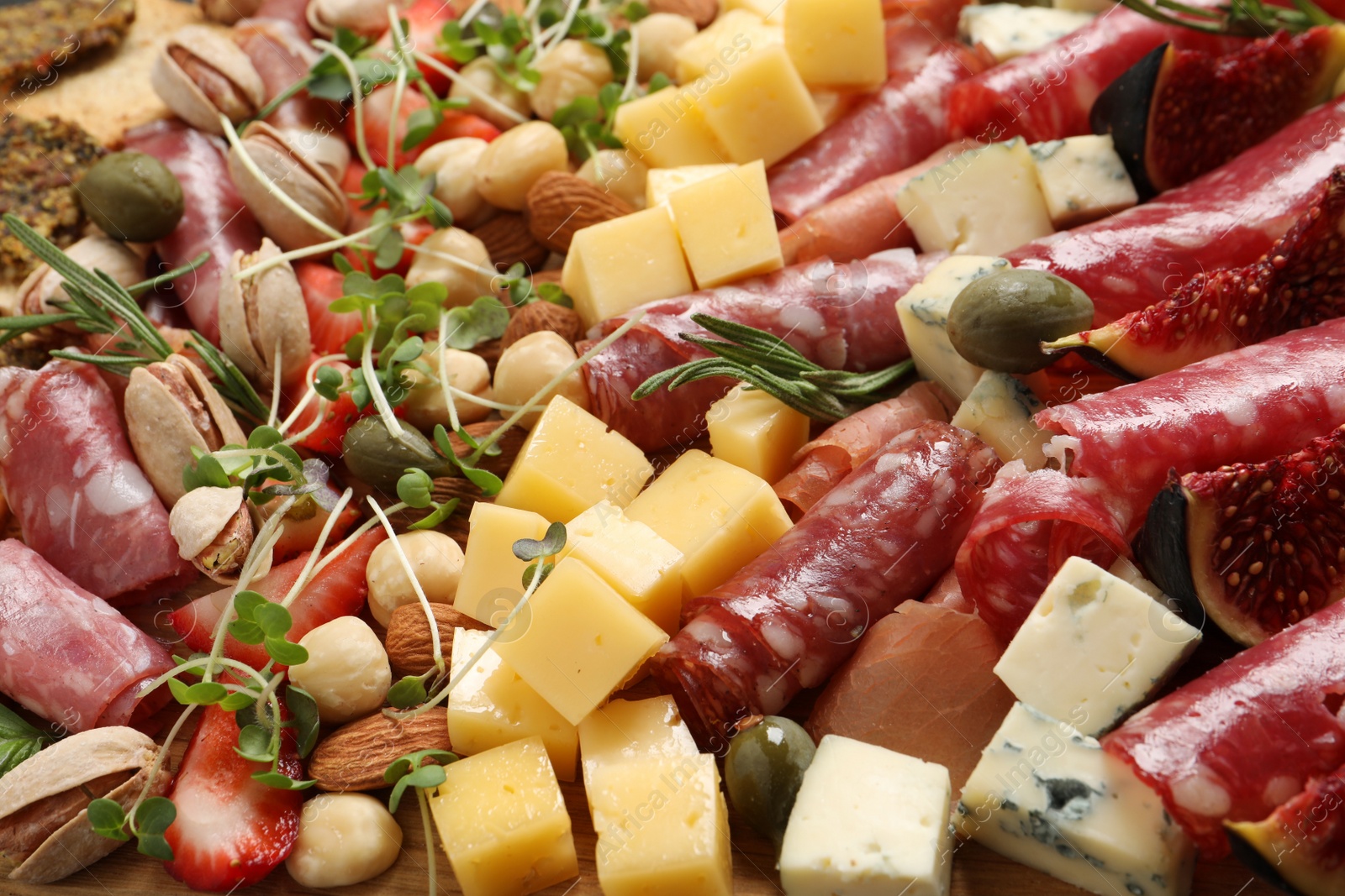 Photo of Different tasty appetizers as background, closeup view