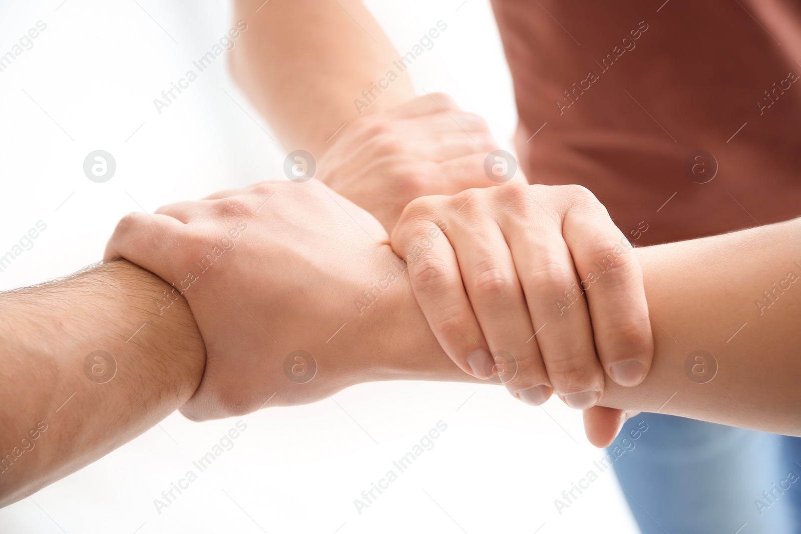 Photo of People holding hands together, closeup. Unity concept