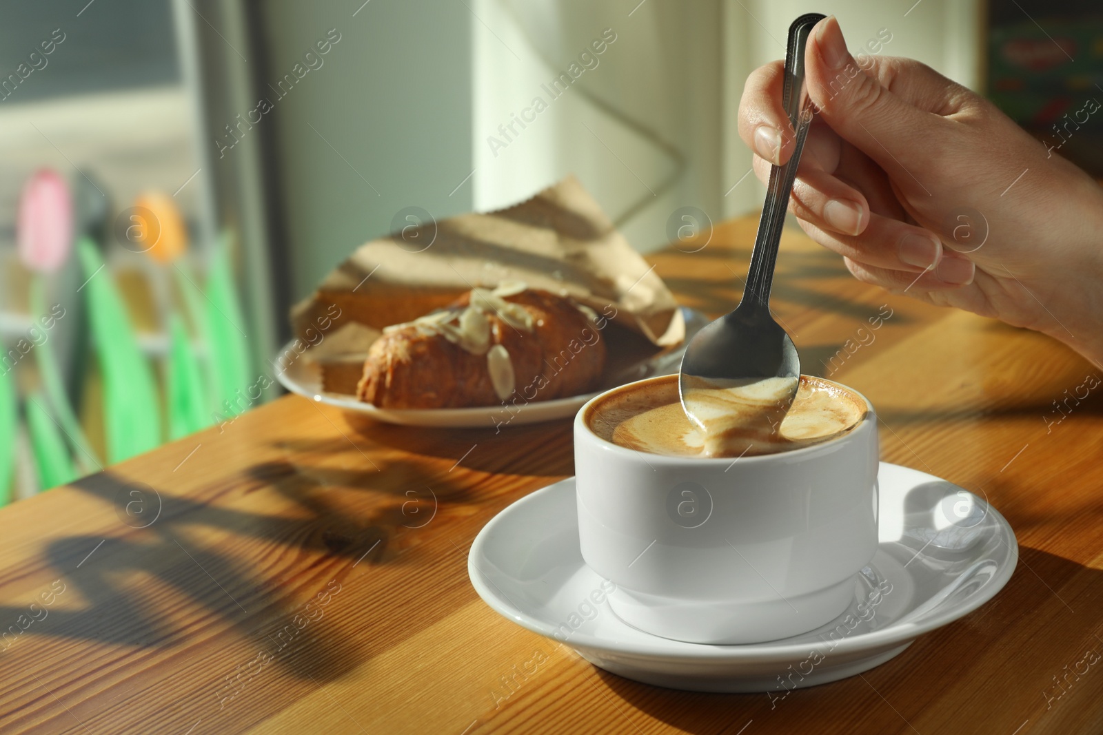 Photo of Woman with cup of fresh aromatic coffee at table in cafe