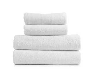 Stack of clean soft towels on white background