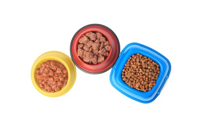 Photo of Dry and wet pet food in feeding bowls isolated on white, top view