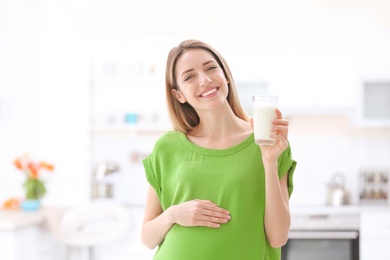Photo of Beautiful pregnant woman drinking milk at home
