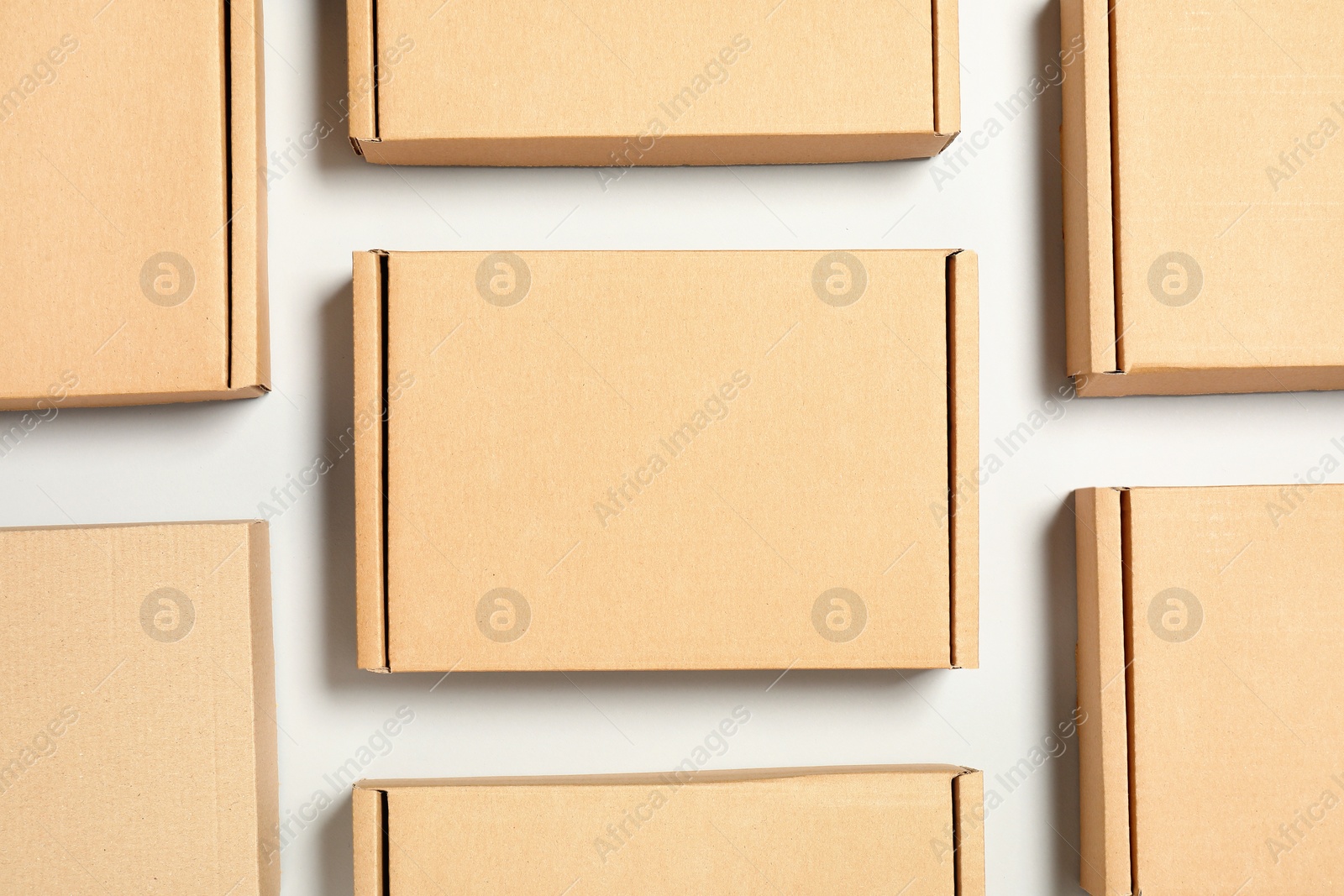 Photo of Many cardboard boxes on white background, flat lay. Packaging goods