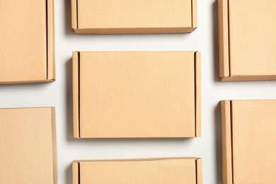 Photo of Many cardboard boxes on white background, flat lay. Packaging goods