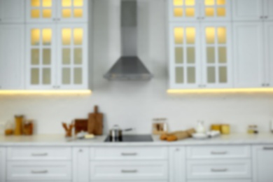 Photo of Blurred view of modern kitchen interior with stylish furniture
