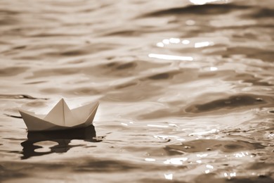 Image of Paper boat floating on river. Retro photo effect