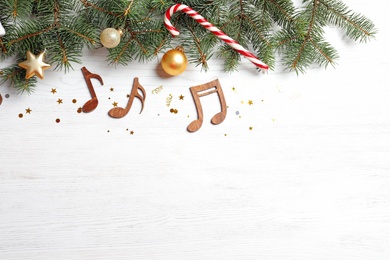 Photo of Flat lay composition with decorations and  notes on wooden background. Christmas music concept