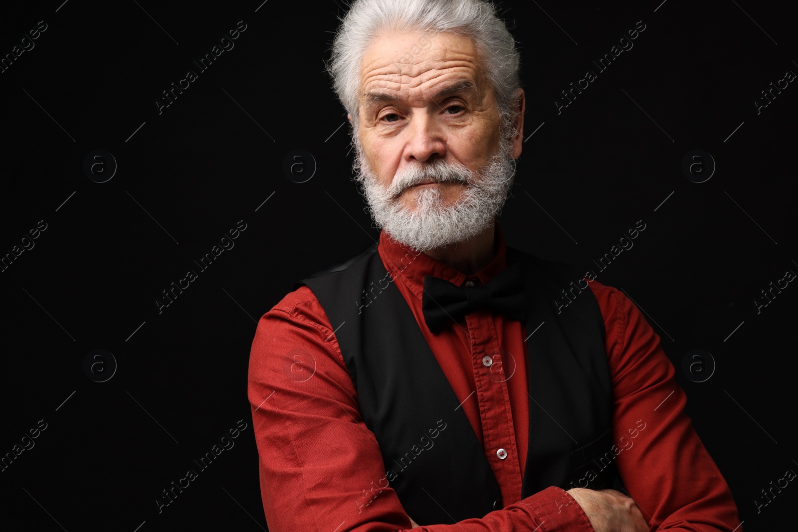 Photo of Senior man with mustache on black background, space for text