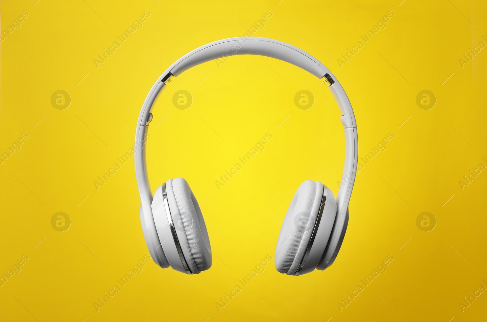 Photo of Stylish modern headphones with earmuffs on color background