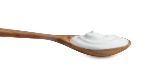 Photo of One wooden spoon with sour cream isolated on white