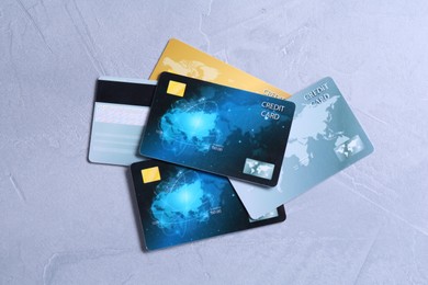Credit cards on grey textured table, top view