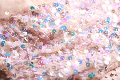 Beautiful pink fabric with shiny sequins as background, closeup