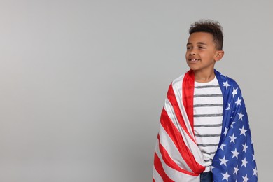 4th of July - Independence Day of USA. Happy boy with American flag on light grey background, space for text