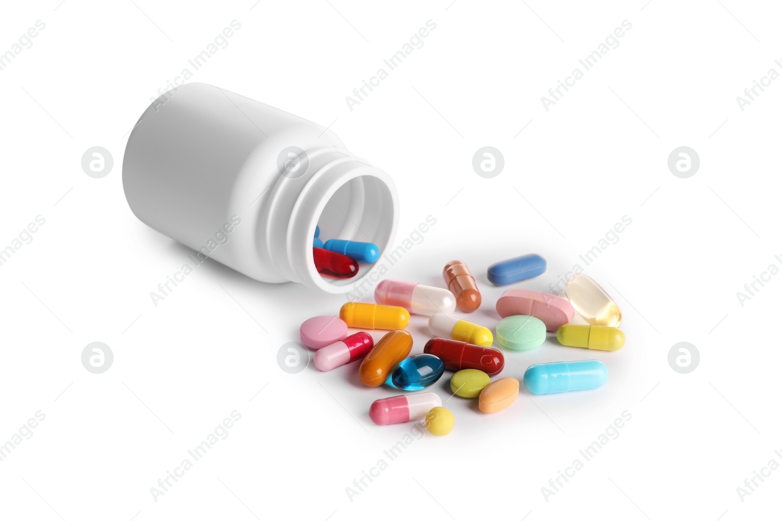 Photo of Plastic medical bottle with many different pills isolated on white