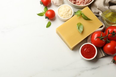 Photo of Ingredients for lasagna on white marble table, flat lay. Space for text