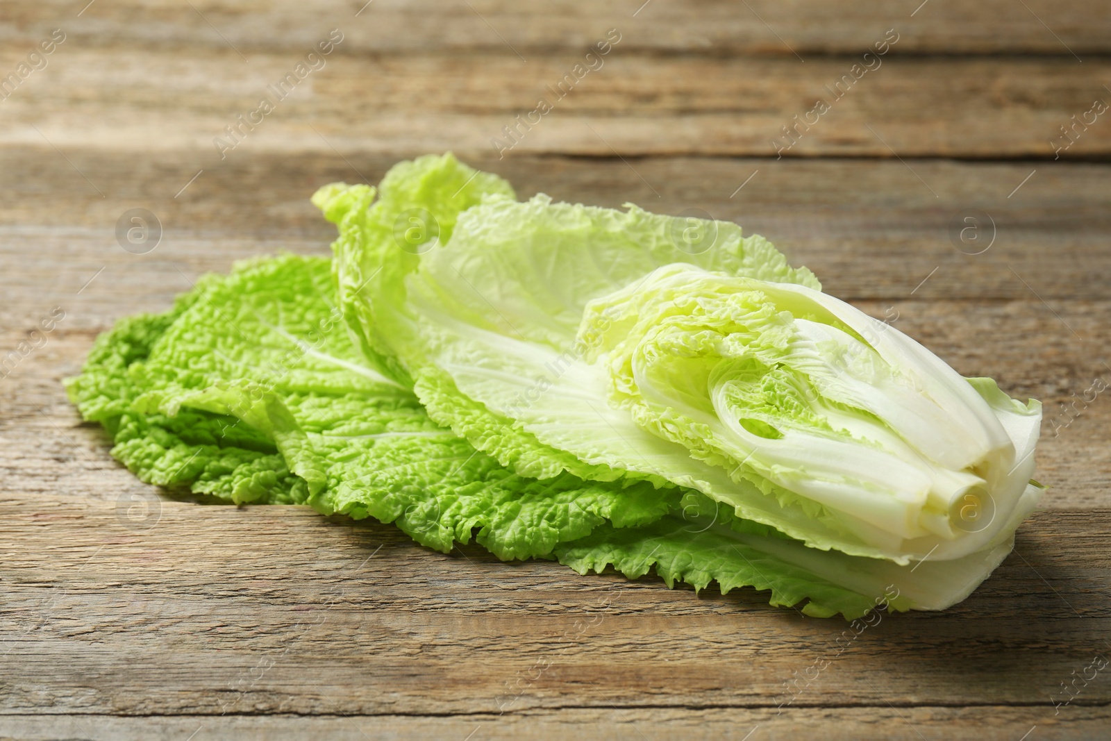 Photo of Cut fresh Chinese cabbage on wooden table